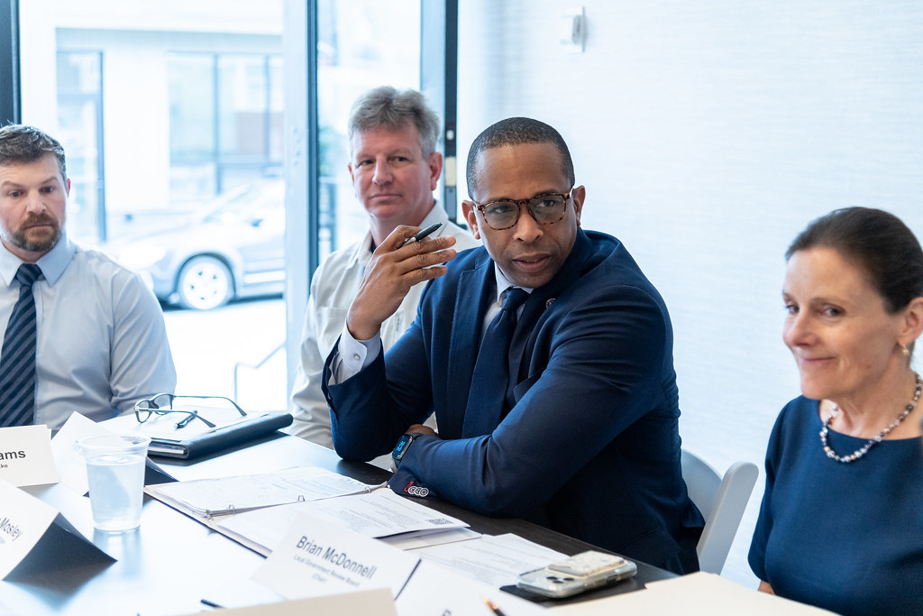 A man talking at a table with three people
