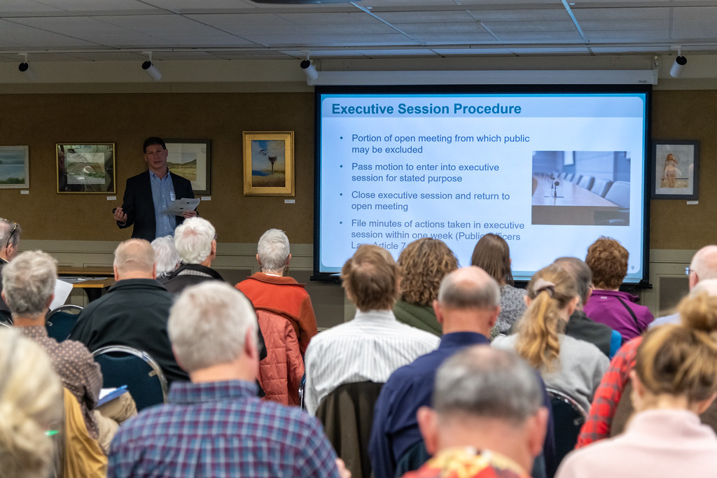 A group of people watching a presentation